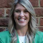 Picture of Kesler Ballew, standing in front of a brick wall with a light green top.